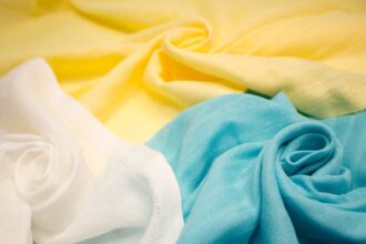 Close-up view of sustainable, environmentally friendly textile fabric, showcasing the texture and natural color of eco-conscious material.